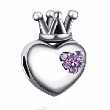 Silver heart-shaped charm with a purple gem and crown on a white background