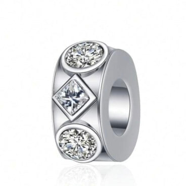 Silver charm with diamond-like stones on a white background