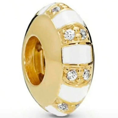 Gold and white beaded charm with clear stones on a white background