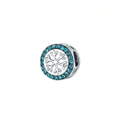 Silver charm with snowflake design and blue stones on a white background